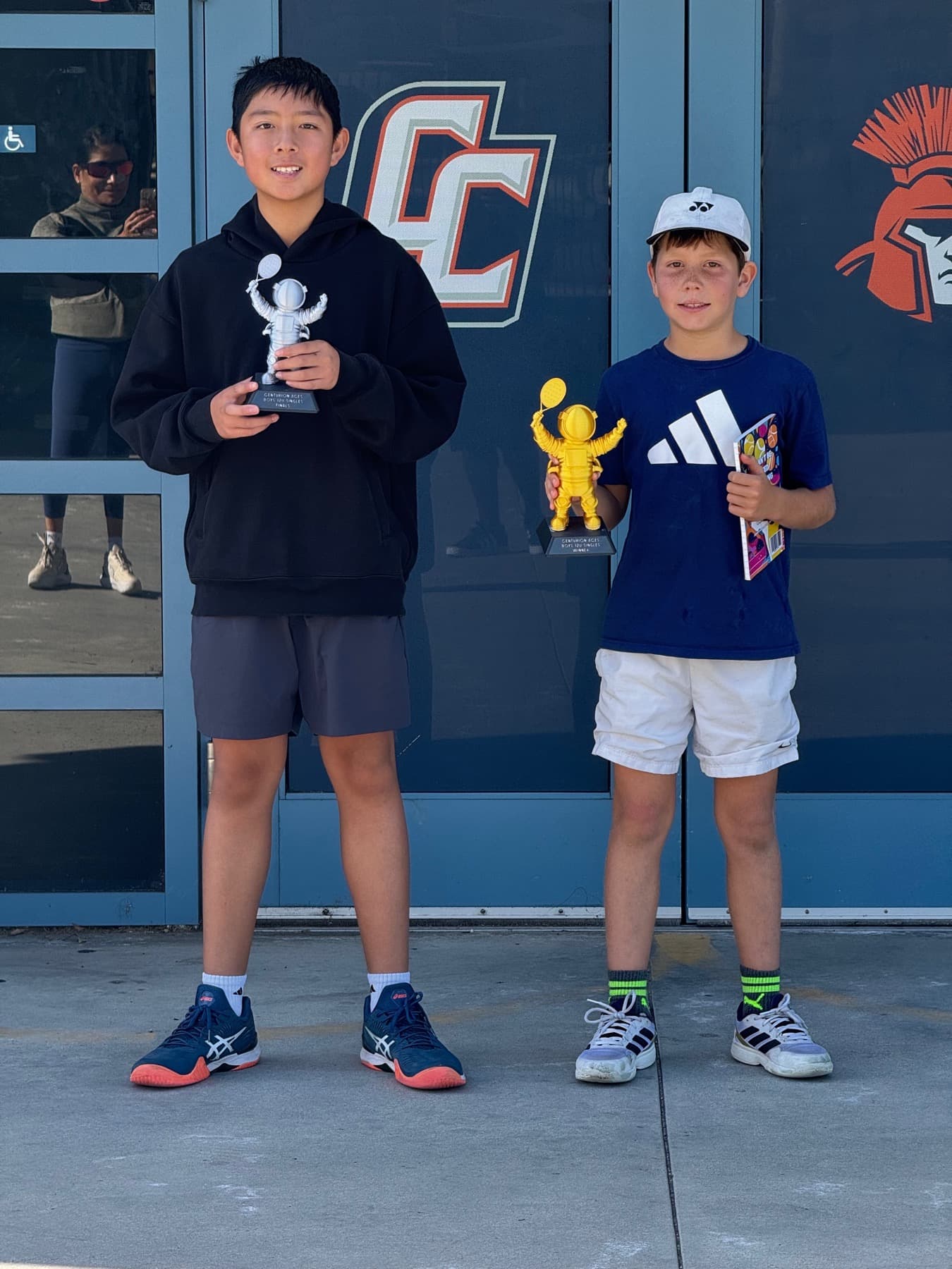 Players holding Centurion Aces trophies on court