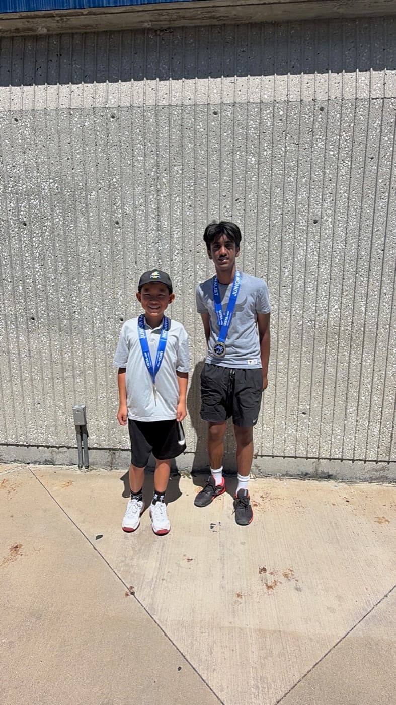 Two players wearing tournament medals