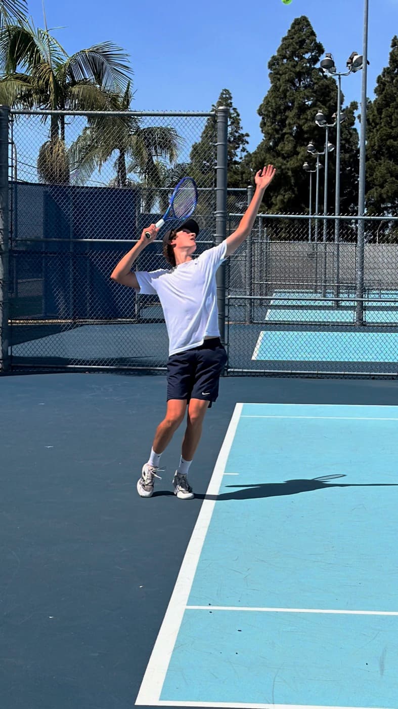 Tennis player serving on court
