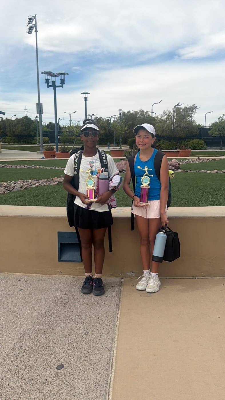 Two players holding trophies