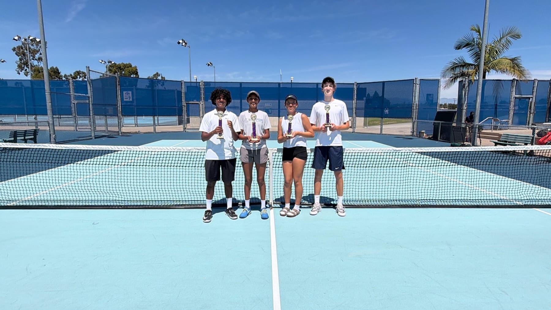 Centurion Aces trophies and tennis balls on court